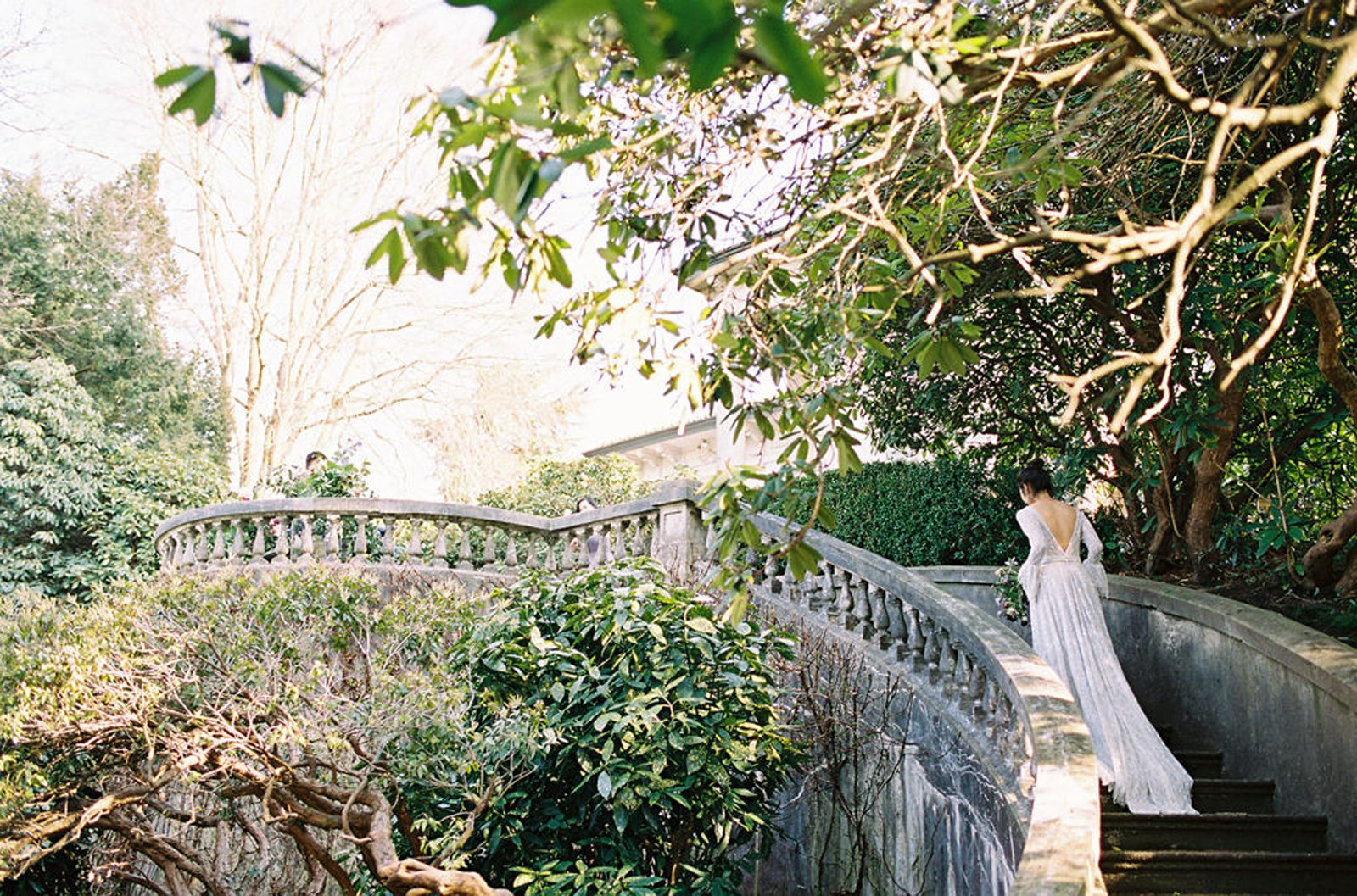 Bride walking up European stairs at Hycroft Manor