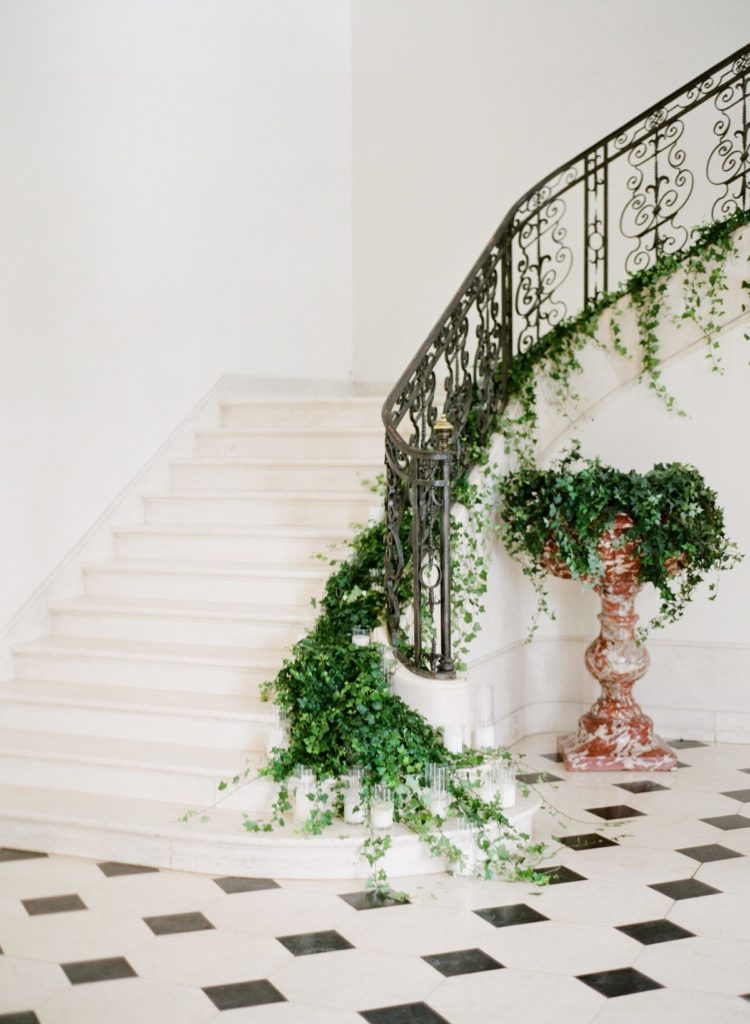 Destination Wedding Planner Chateau De La Hulpe indoor staircase with greenery