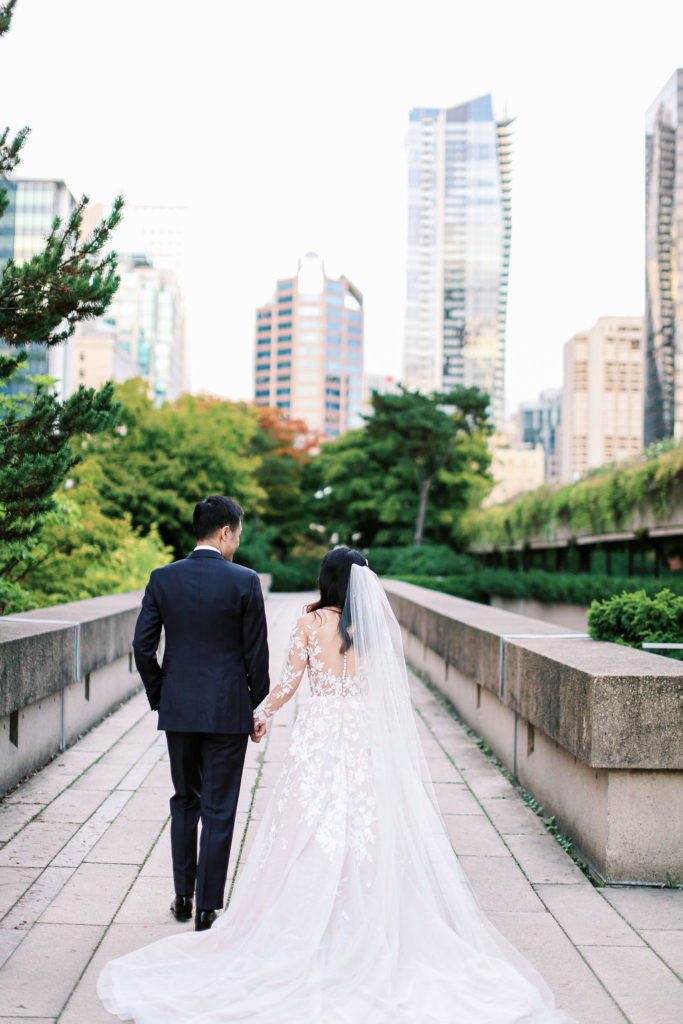 wedding couple walking in vancouver holding hands