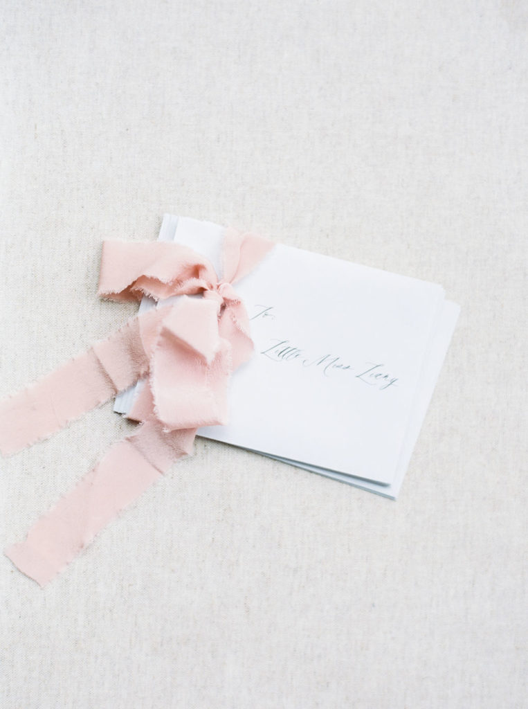 Letters to newborn wrapped with pink ribbon