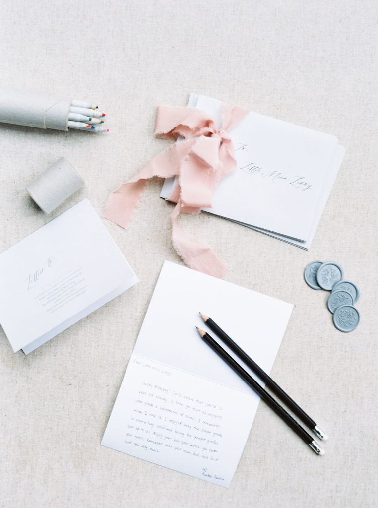 Flatlay of letters with stationery to newborn