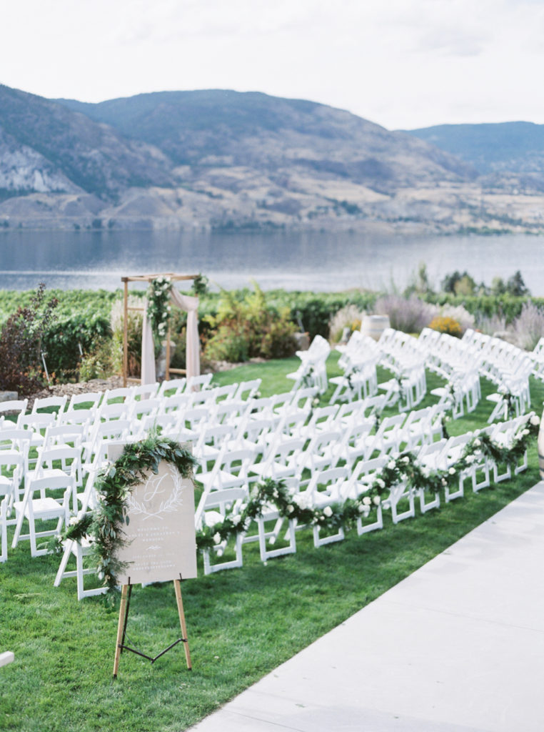 Wedding ceremony with chairs beside lake