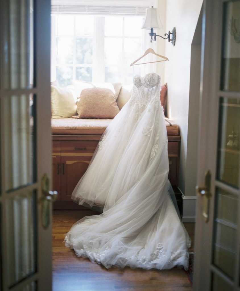 Wedding dress hanging in room