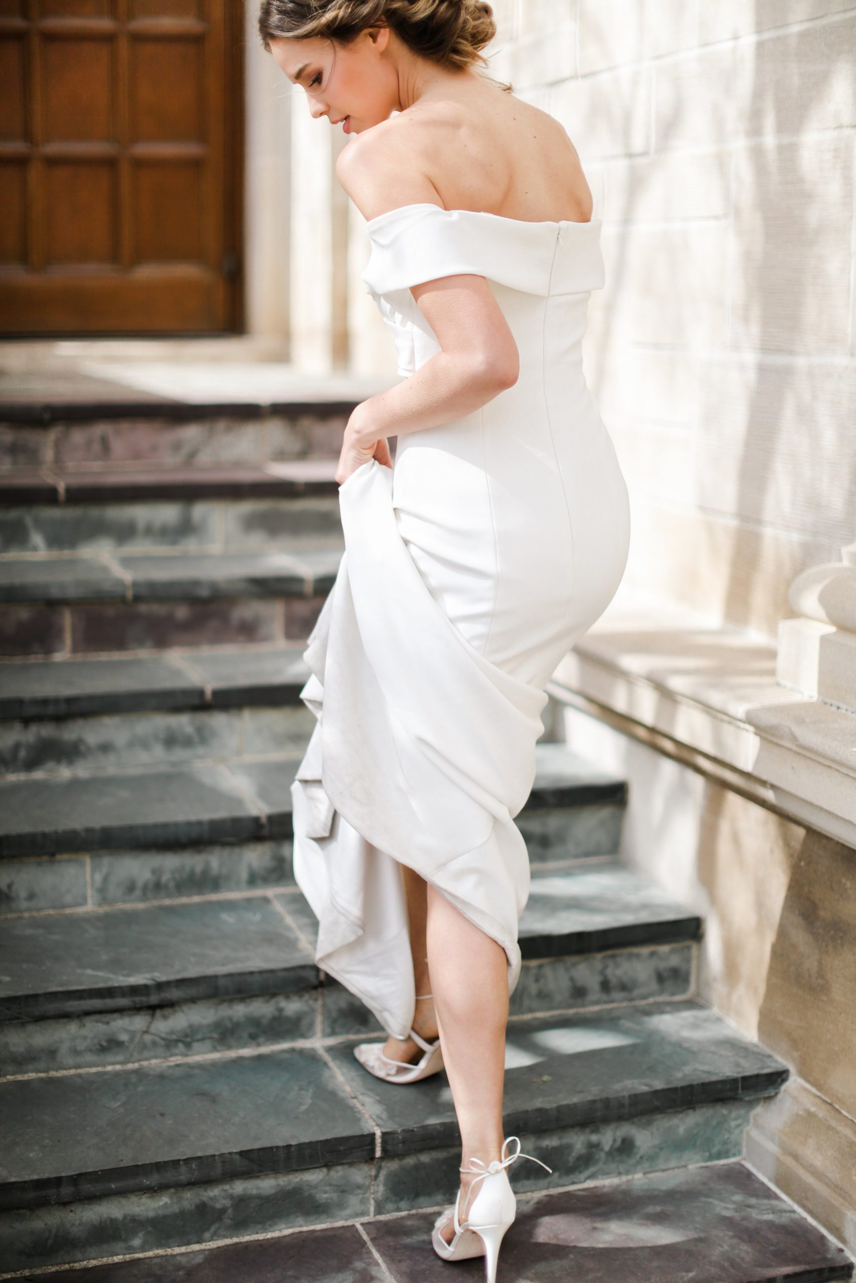 Lady holding a white wedding dress