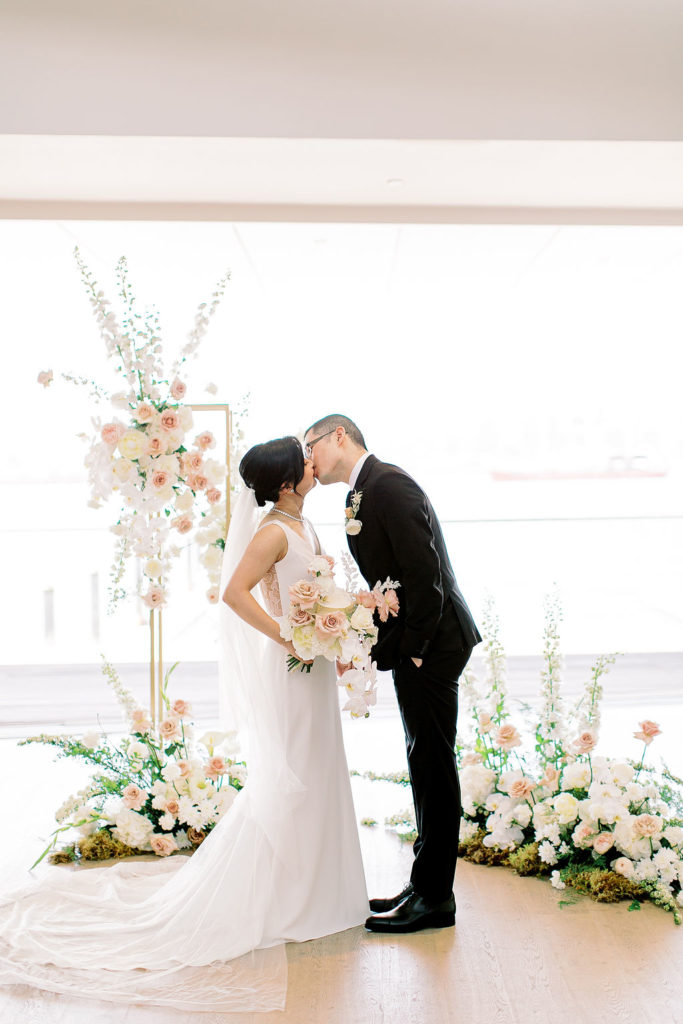 couple shares a kiss at polygon gallery wedding