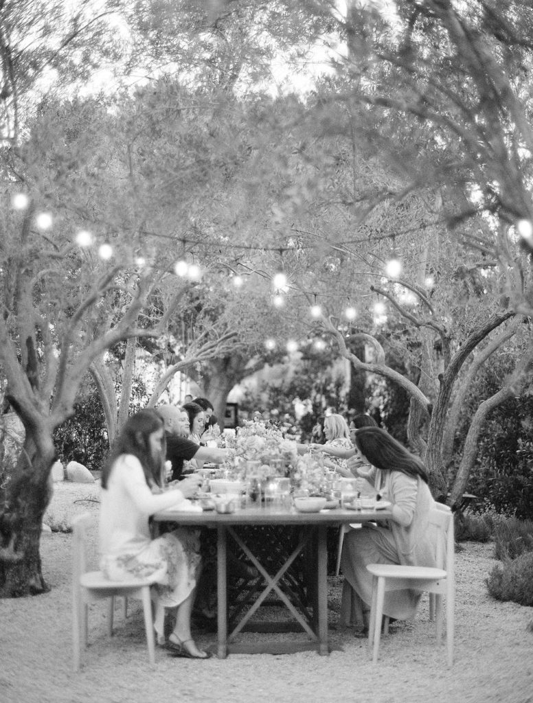 black and white reception guests seated at long table