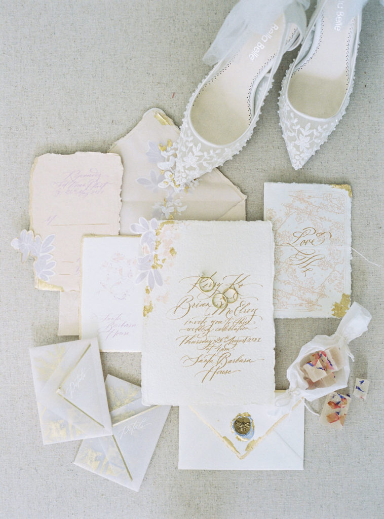 classic and luxury invitation flat lay with shoes and candy