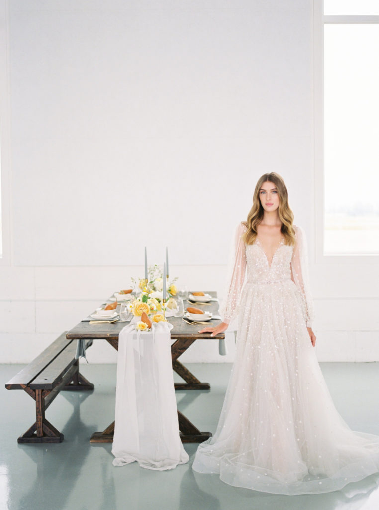 Fall bride standing by reception table