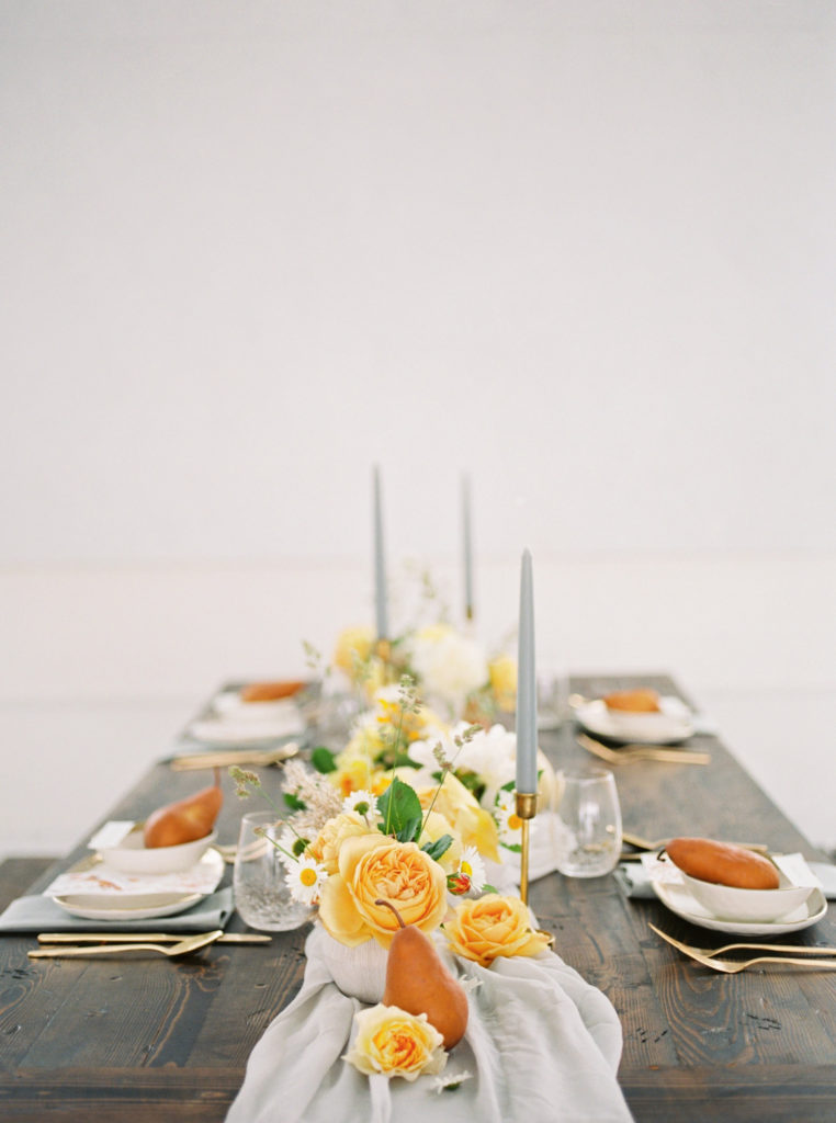Place setting with pears and flowers on wooden table