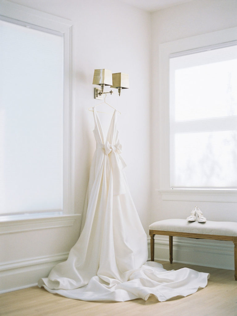 Classic ivory gown hanging on lamp