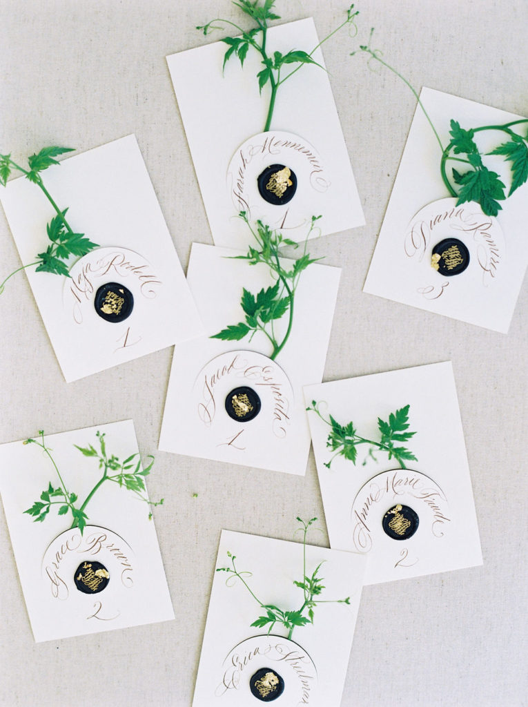 Escort cards with greenery and wax seals