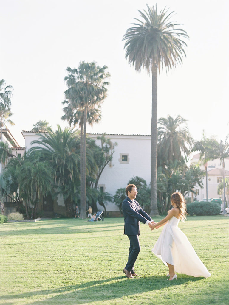 Couple dancing on grass lawn