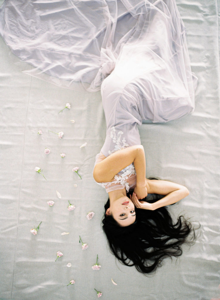 Bride laying down with qipao dress
