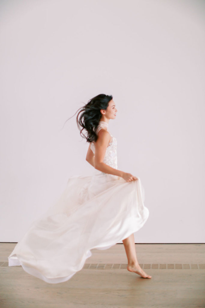 Bride running in modern qipao wedding dress
