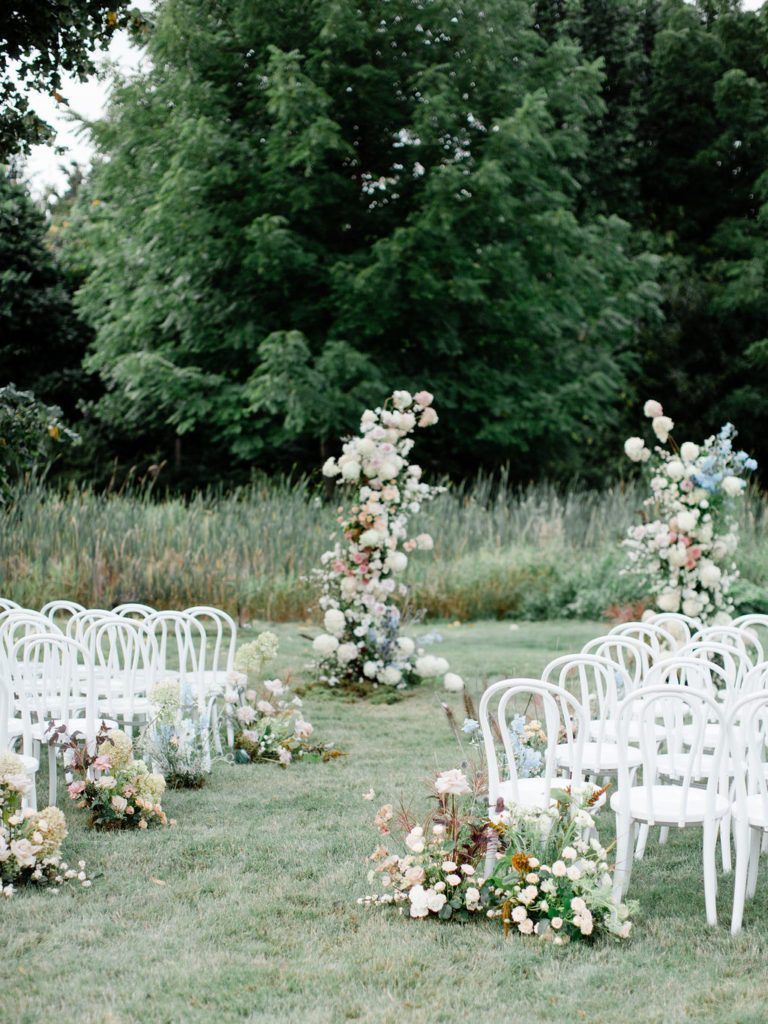 ceremony arch and white chairs