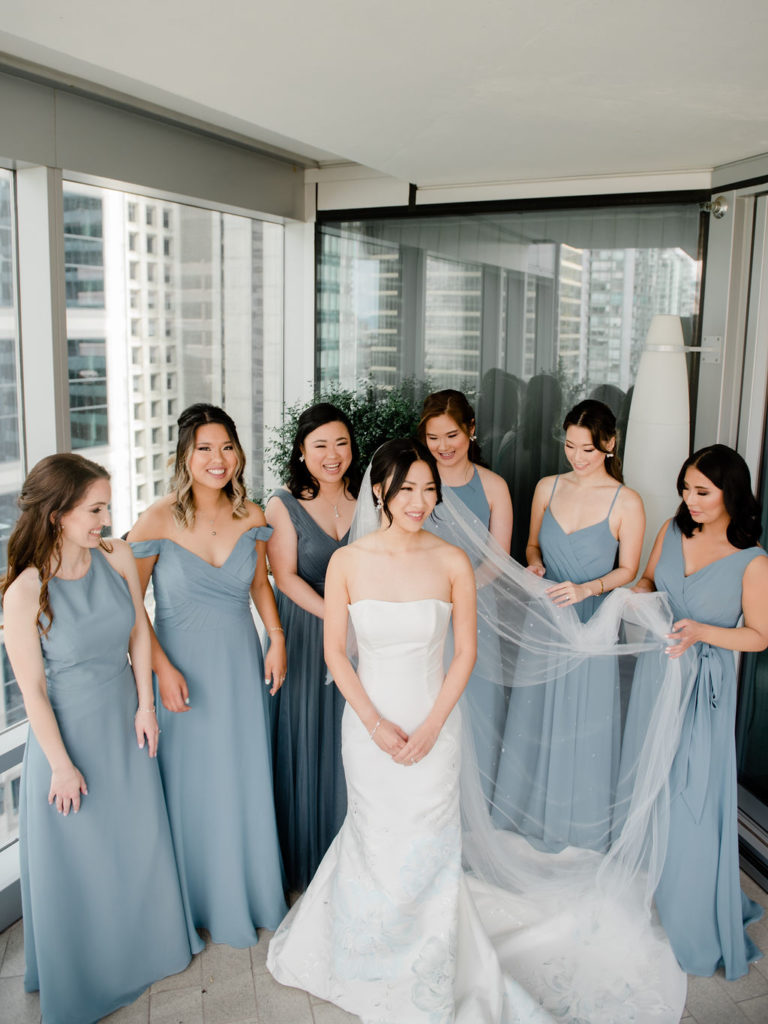 bridesmaids holding bride's veil