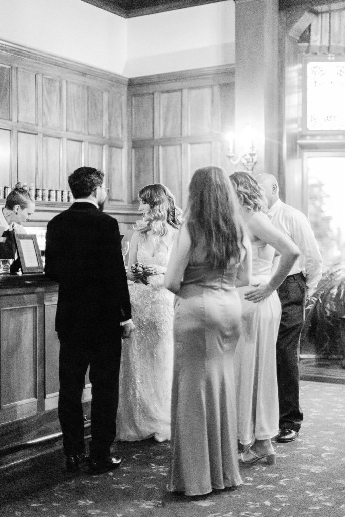 bride and groom at bar with guests