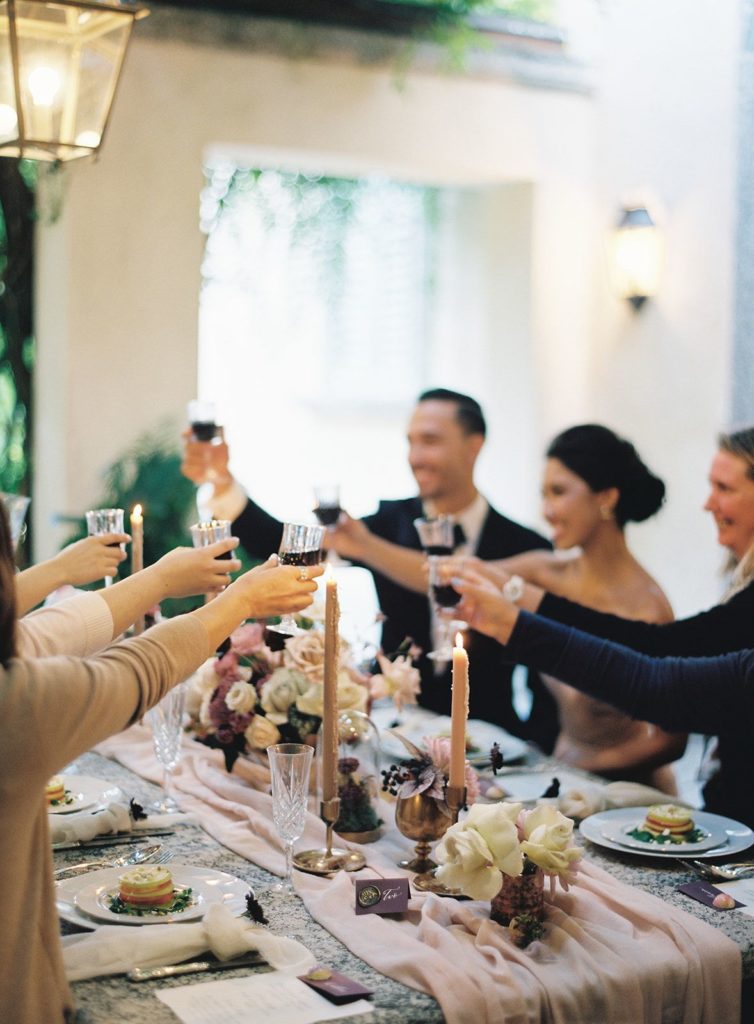 Couple and guests toasting at reception