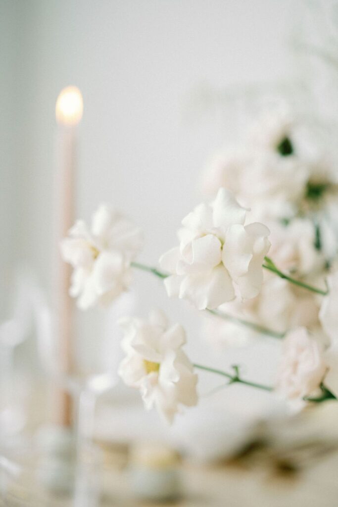 white floral arrangement with candle