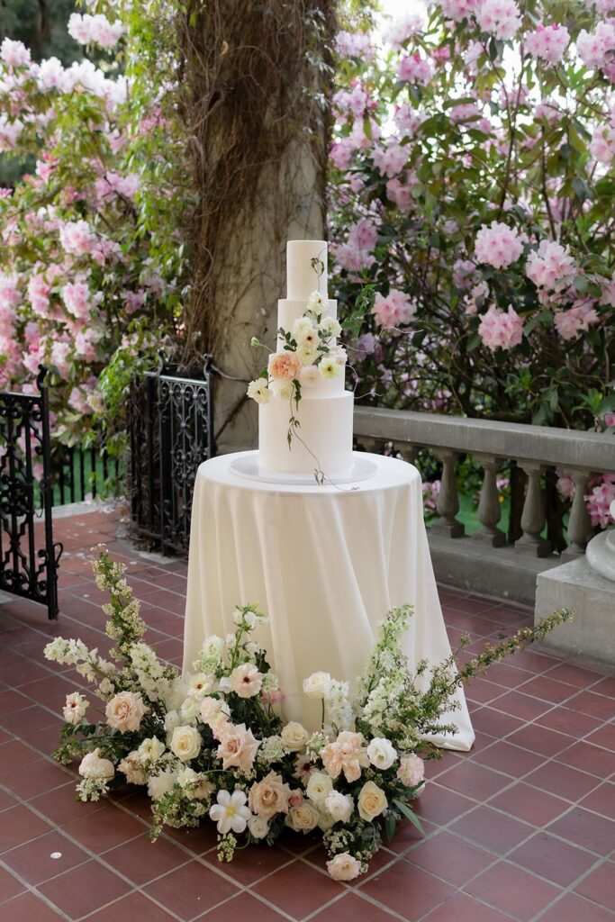 wedding cake surrounded by flowers