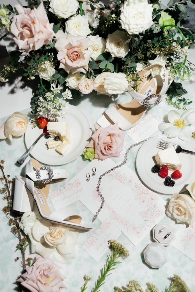 flatlay of cake and shoes and flowers