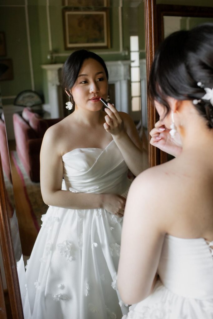 bride putting on lipstick