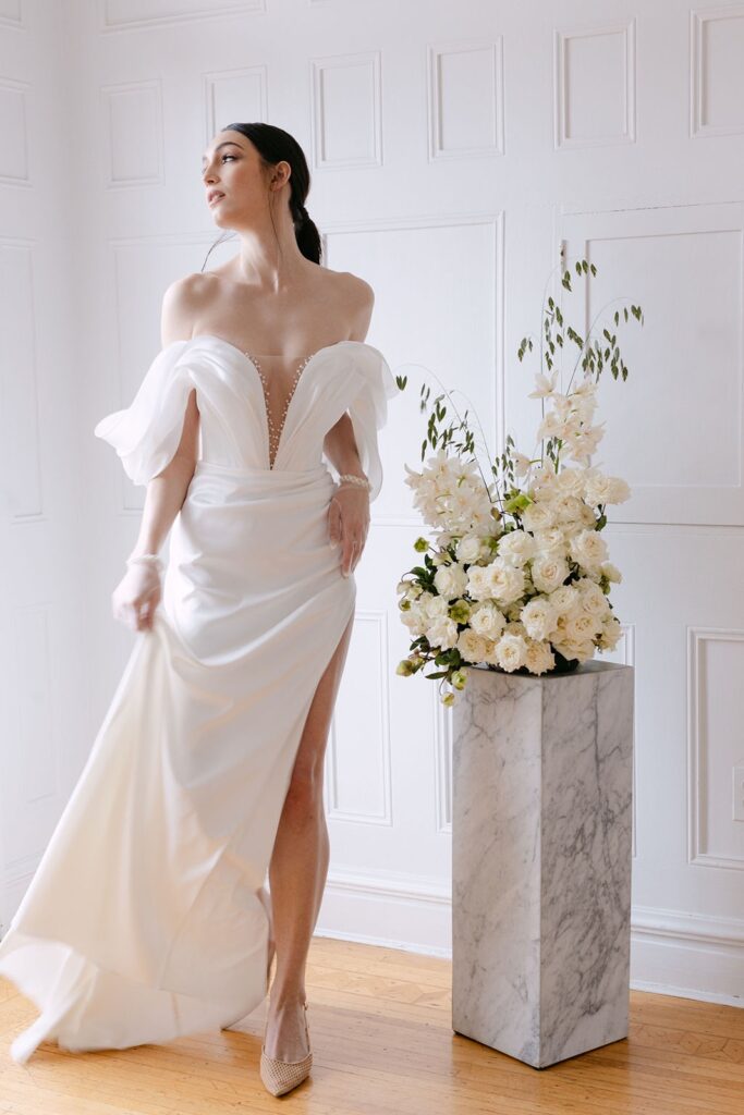 bride beside floral arrangement