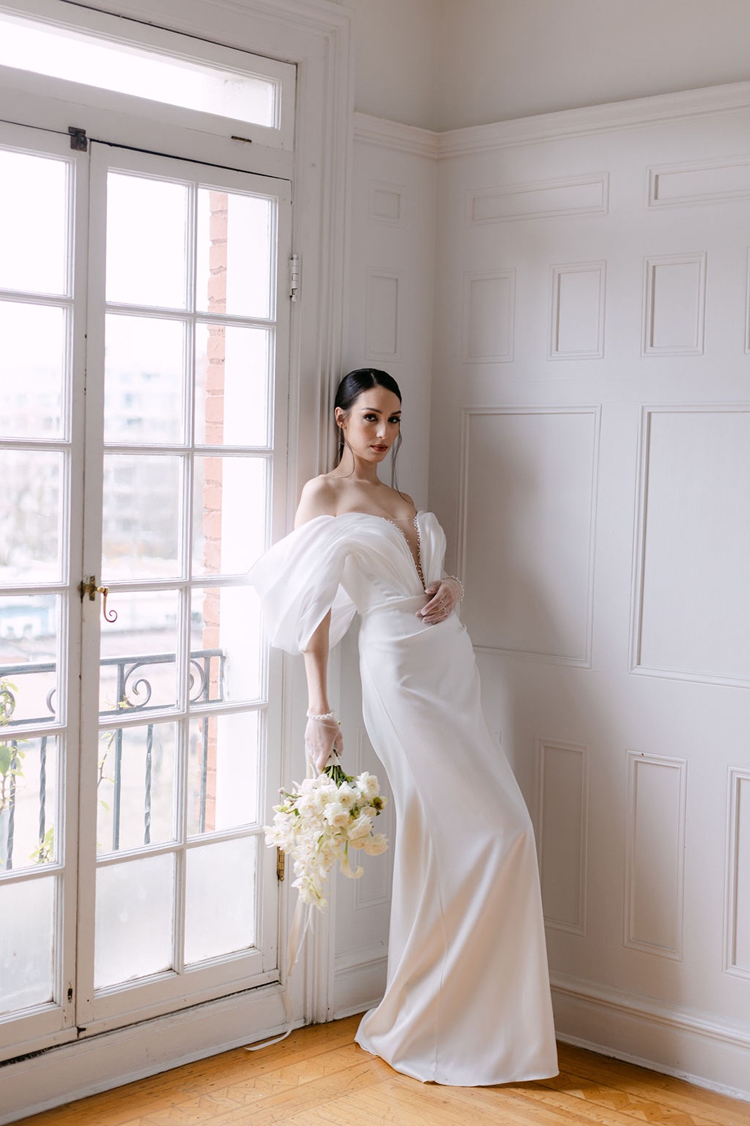 bride leaning against French doors