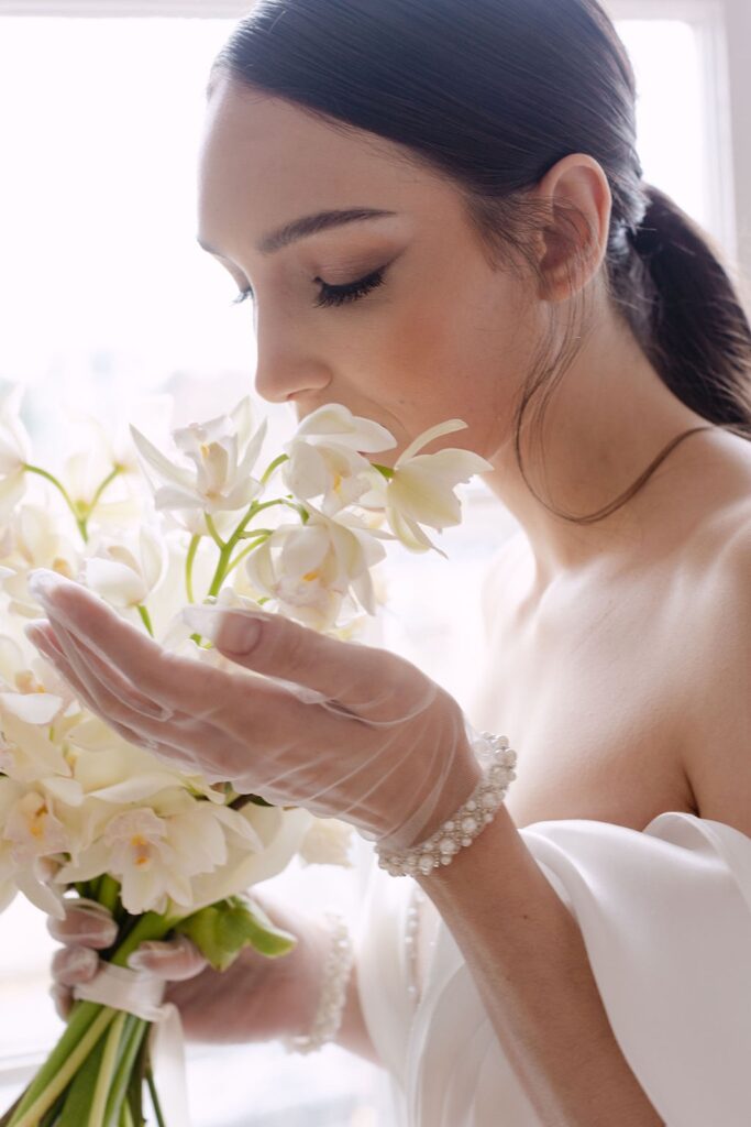 bride smelling flowers