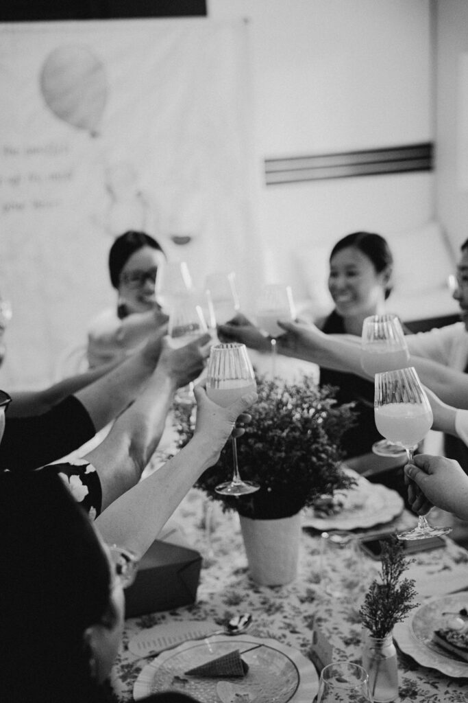 Vancouver baby shower guests clinking glasses