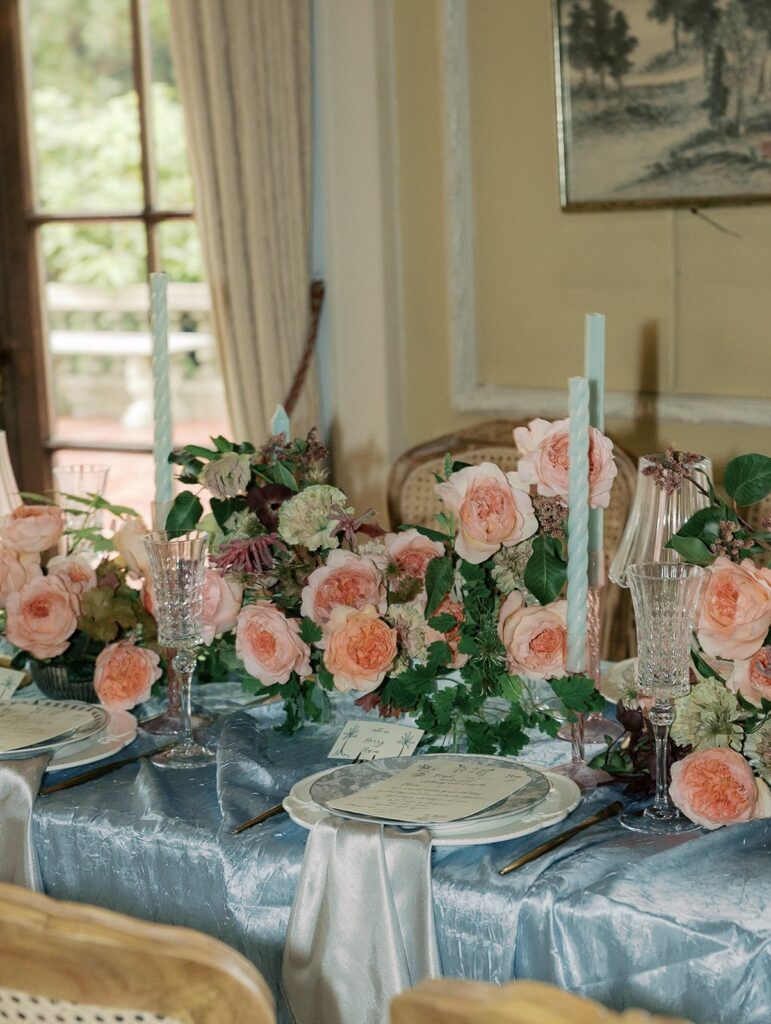 coral centrepieces with candles and plates