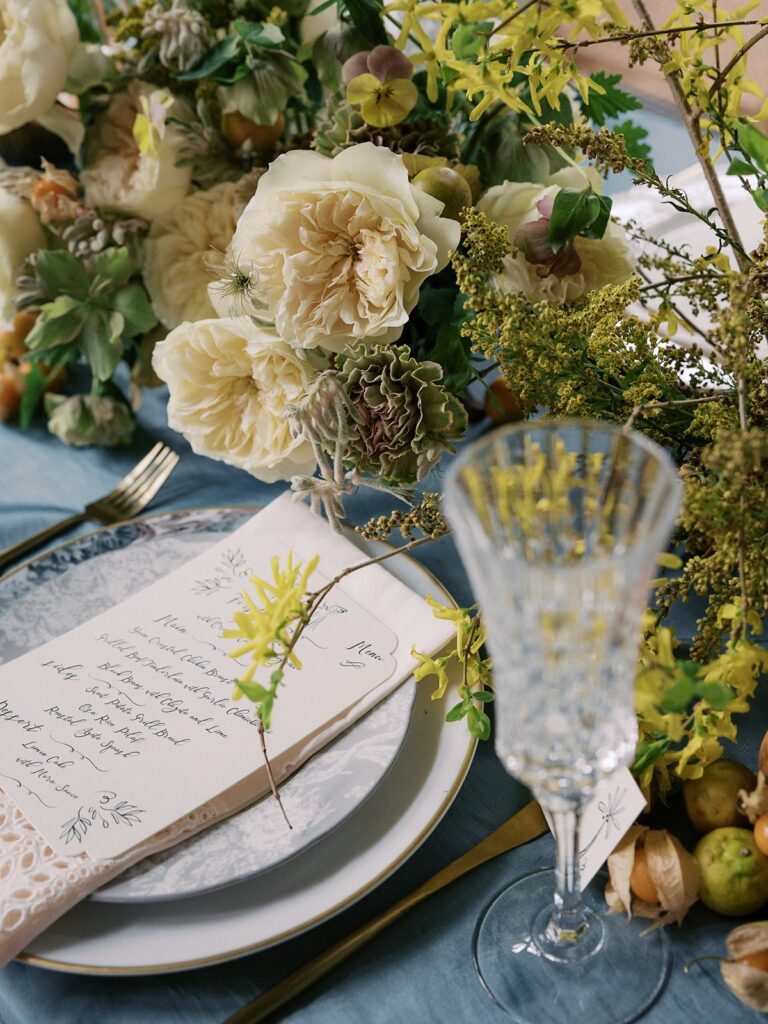 side view of centrepiece, wine glass and menu