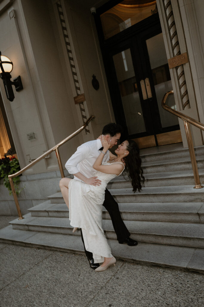 Couple about to kiss at Vancouver Club main entrance