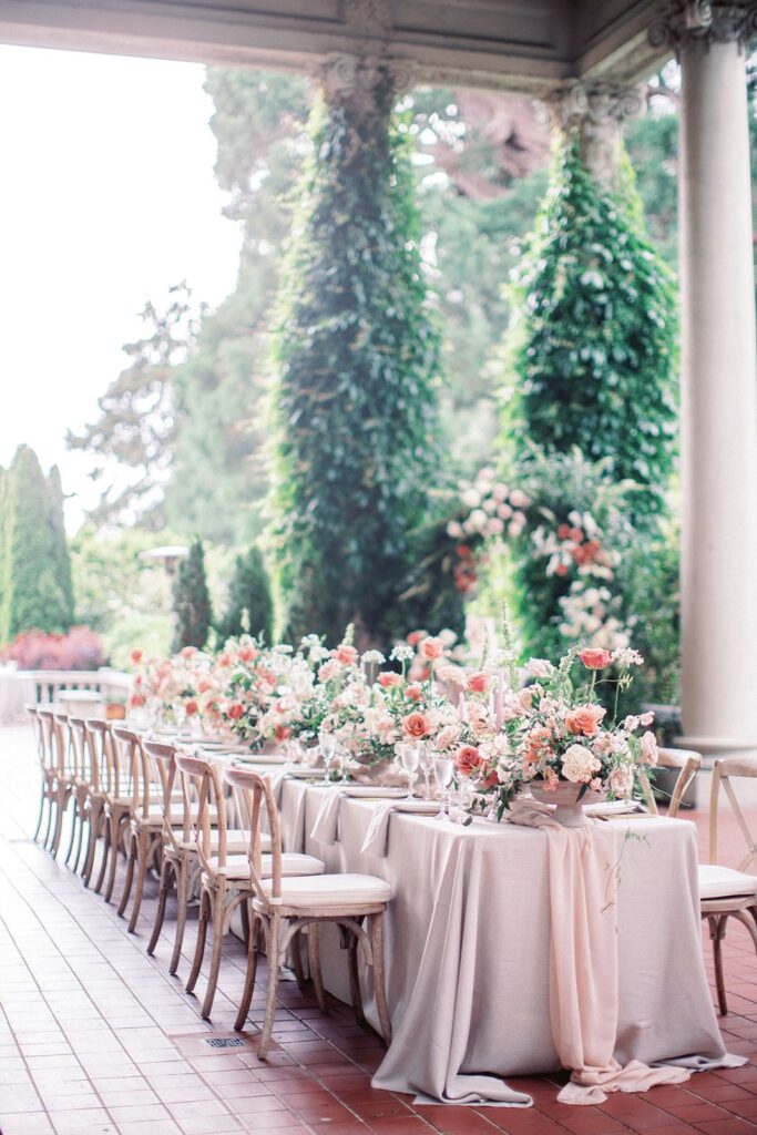 terrace long table reception with peach hues