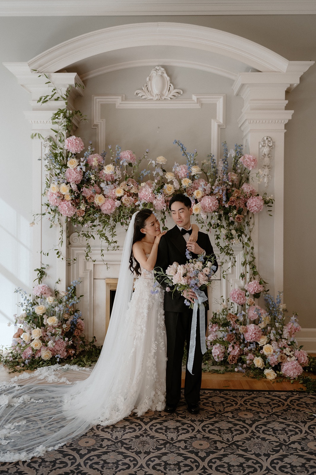 newlyweds in front of mantle Georgian Room