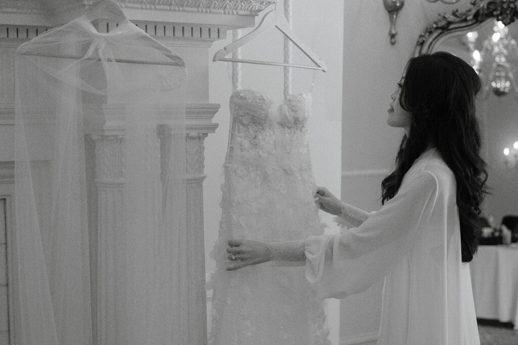 bride looking at wedding attire